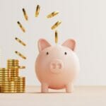 coins floating into a piggy bank