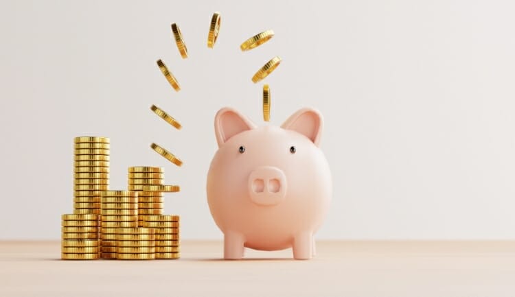 coins floating into a piggy bank