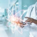 a doctor holds an iPad, overlaid with graphics of engineering