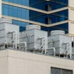 5 commercial HVAC units atop a multi-story building
