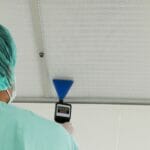 hospital staff scans an air filter with a device
