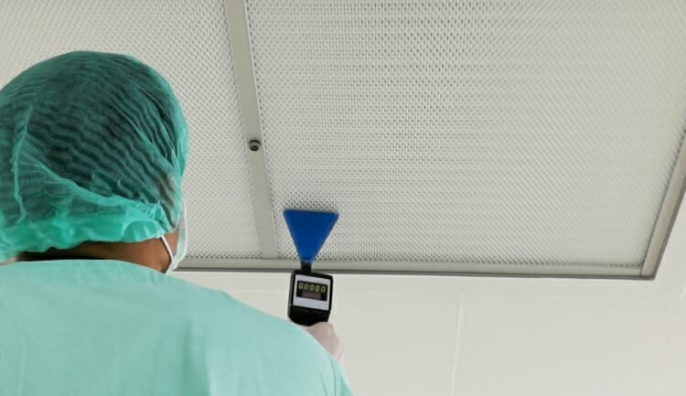 hospital staff scans an air filter with a device