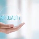 hand holding a bubble labeled air quality