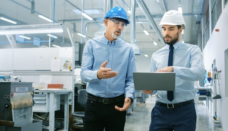 two men walking through manufacturing facility