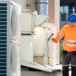 two electricians checking commercial hvac system