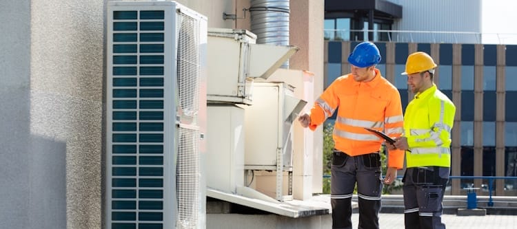 two electricians checking commercial hvac system
