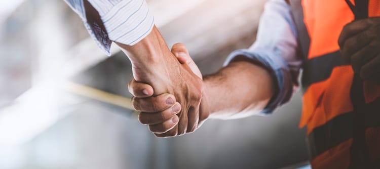 AEC team member and manufacturer shaking hands