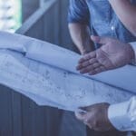 contractors discussing hospital blueprints