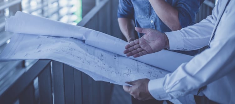 contractors discussing hospital blueprints